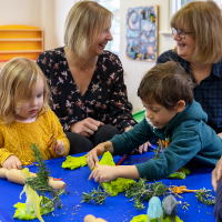 mother and seniors with children playing at an intergenerational playgroup